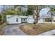 Light blue house exterior with a driveway and landscaping at 3510 Dellefield St, New Port Richey, FL 34655