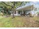 House exterior showcasing a covered patio and lush landscaping at 3510 Dellefield St, New Port Richey, FL 34655