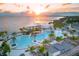 Aerial view of Sunseeker Resort Charlotte Harbor's expansive pool area at sunset, overlooking the waterfront at 3560 Tripoli Blvd, Punta Gorda, FL 33950