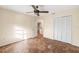 Bright bedroom with tile floors, ceiling fan, and spacious closet at 3560 Tripoli Blvd, Punta Gorda, FL 33950