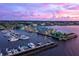 Aerial view of a marina at sunset with boats and waterfront buildings at 3560 Tripoli Blvd, Punta Gorda, FL 33950