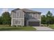 Two-story house with gray siding, brown garage door, and landscaping at 3632 Forest Path Dr, Plant City, FL 33565