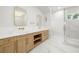 Bathroom boasting double vanity, marble countertop, and a glass door shower with gold trim at 3640 15Th N St, St Petersburg, FL 33704