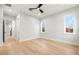 Bright bedroom featuring hardwood floors, neutral walls, ceiling fan, and natural light from two windows at 3640 15Th N St, St Petersburg, FL 33704