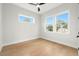 A simple bedroom with hardwood floors, a ceiling fan and a view from a window at 3640 15Th N St, St Petersburg, FL 33704