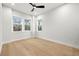 Bright bedroom featuring hardwood floors, white walls, large windows, and a modern ceiling fan at 3640 15Th N St, St Petersburg, FL 33704