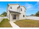 Side view of a two-story home showcasing white siding, black trim, porch, and fenced yard at 3640 15Th N St, St Petersburg, FL 33704