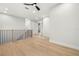 Upstairs hallway with light wood flooring, white walls, black metal railing, and recessed lighting at 3640 15Th N St, St Petersburg, FL 33704