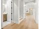 Inviting hallway featuring hardwood floors, a powder room, and an archway leading to the kitchen at 3640 15Th N St, St Petersburg, FL 33704