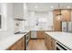 A modern kitchen design featuring white countertops and stainless steel appliances and wooden cabinetry at 3640 15Th N St, St Petersburg, FL 33704