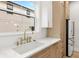 A kitchen sink with white countertops, a stainless steel fridge and wooden cabinetry at 3640 15Th N St, St Petersburg, FL 33704