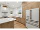 A kitchen island with white countertops and stainless steel appliances at 3640 15Th N St, St Petersburg, FL 33704