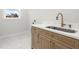 Laundry room featuring a quartz countertop with stainless steel sink and wooden cabinets at 3640 15Th N St, St Petersburg, FL 33704