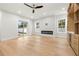 Cozy living room featuring a modern fireplace, a ceiling fan, and sliding glass doors to the backyard at 3640 15Th N St, St Petersburg, FL 33704