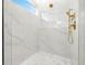 Modern shower featuring a rainfall shower head, handheld sprayer, marble style tile and mosaic tiled floor at 3640 15Th N St, St Petersburg, FL 33704