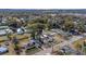 Aerial view of a charming home with a well-manicured lawn and solar panels at 37620 Howard Ave, Dade City, FL 33525