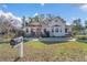 Charming light-yellow house with a well-maintained lawn and stone accents at 37620 Howard Ave, Dade City, FL 33525