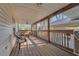 Relaxing screened porch with wooden flooring and seating at 37620 Howard Ave, Dade City, FL 33525