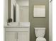 Modern bathroom with white vanity and green walls at 3945 Northern Key Dr, Plant City, FL 33563