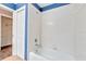 Bathroom with white tile, a bathtub and blue walls at 4020 Concord Way, Plant City, FL 33566