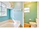 Clean bathroom with a bathtub, toilet and window at 4020 Concord Way, Plant City, FL 33566