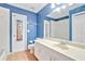 Clean bathroom with blue walls, white tile, and vanity at 4020 Concord Way, Plant City, FL 33566