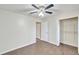 Well-lit bedroom with ceiling fan, tile floor, and large closet at 4020 Concord Way, Plant City, FL 33566