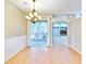 Bright dining room with tile floors, chandelier, and access to a patio at 4020 Concord Way, Plant City, FL 33566