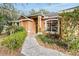 House entrance with walkway, well-manicured hedges and landscaping at 4020 Concord Way, Plant City, FL 33566