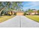 Two-story house with a large driveway and mature trees at 4020 Concord Way, Plant City, FL 33566