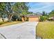 Single-story house with orange exterior and a two-car garage, mature trees at 4020 Concord Way, Plant City, FL 33566