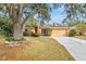 Single-story house with orange exterior, a two-car garage, and landscaping at 4020 Concord Way, Plant City, FL 33566