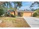 Front view of a single story house with orange exterior and a two-car garage at 4020 Concord Way, Plant City, FL 33566