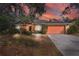 Single-story house with orange siding, attached garage, and landscaping at 4020 Concord Way, Plant City, FL 33566