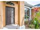 Dark gray front door with sidelights and arched window above at 4020 Concord Way, Plant City, FL 33566