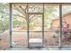 Spacious screened porch overlooking the backyard with lush landscaping and large oak trees at 4020 Concord Way, Plant City, FL 33566