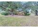 Side yard view, showing mature trees and landscaping at 4020 Concord Way, Plant City, FL 33566