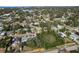 An aerial shot showing a suburban neighborhood with lush vegetation and homes at 436 Norfolk St, Dunedin, FL 34698