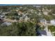 Aerial view of a residential neighborhood showcasing tree-lined streets and houses at 436 Norfolk St, Dunedin, FL 34698