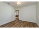 Bright bedroom with hardwood floors and a view into the living room at 436 Norfolk St, Dunedin, FL 34698