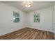 Spacious bedroom with hardwood floors and two bright windows at 436 Norfolk St, Dunedin, FL 34698