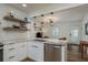 Modern kitchen with white cabinets, marble countertops, and stainless steel appliances at 436 Norfolk St, Dunedin, FL 34698