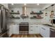 Modern kitchen with white cabinets, marble countertops, and stainless steel appliances at 436 Norfolk St, Dunedin, FL 34698