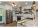 Modern kitchen with white cabinets, marble countertops, and stainless steel appliances at 436 Norfolk St, Dunedin, FL 34698