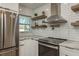 Modern kitchen with white cabinets, marble countertops, and stainless steel appliances at 436 Norfolk St, Dunedin, FL 34698