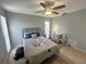 Spacious bedroom with a queen-size bed, tiled floors, and a ceiling fan at 4498 Lake Blvd, Clearwater, FL 33762