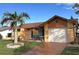 Cute one-story home with palm trees and a well-maintained lawn at 4498 Lake Blvd, Clearwater, FL 33762