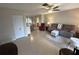 Bright living room featuring tiled floors, comfy seating, and views into the dining area at 4498 Lake Blvd, Clearwater, FL 33762