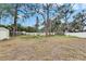 Large backyard with mature trees and privacy fence at 4646 W Longfellow Ave, Tampa, FL 33629