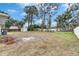 Spacious backyard with mature trees and landscaping at 4646 W Longfellow Ave, Tampa, FL 33629